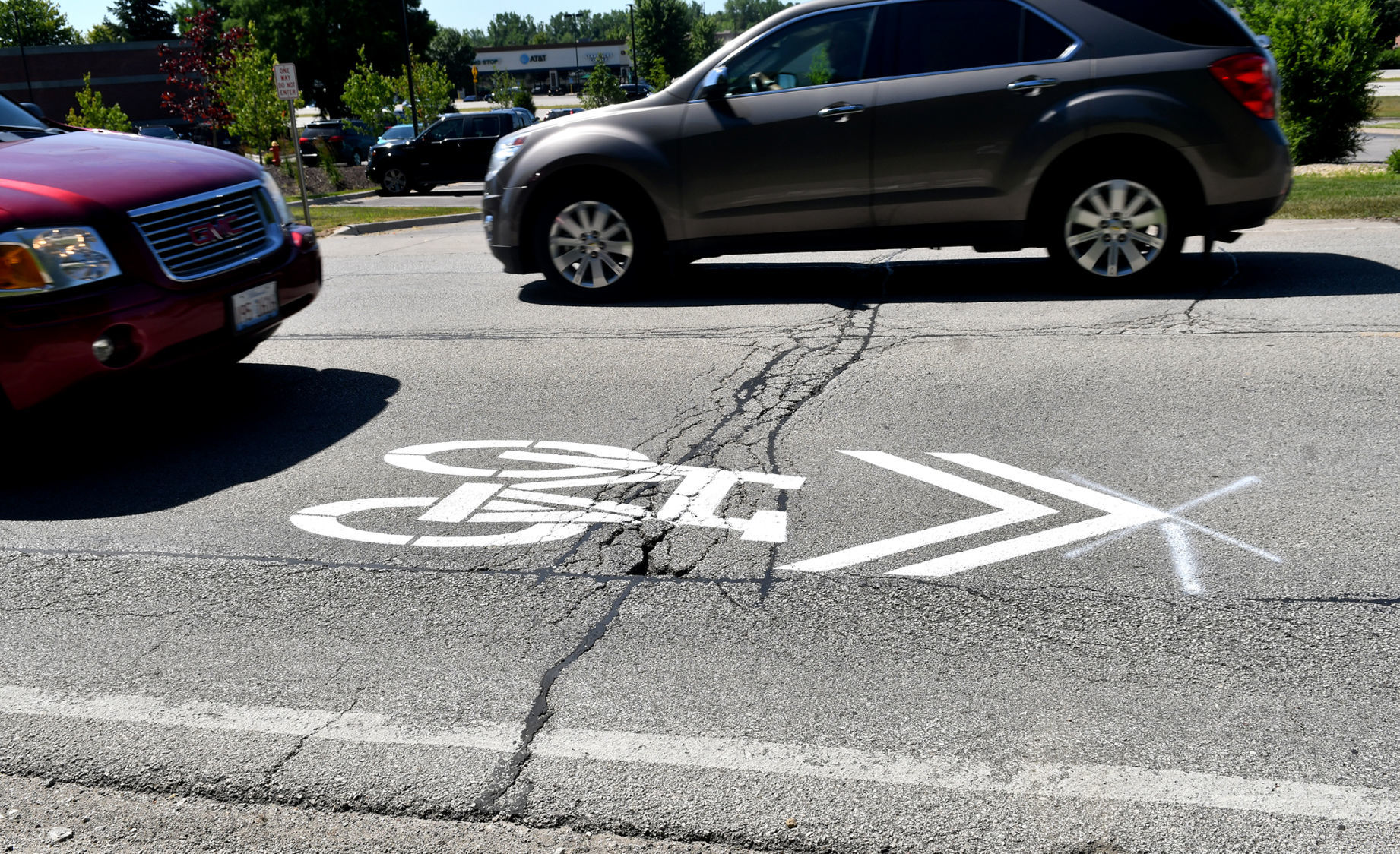 Painting of sharrows for bike lanes in Moline.